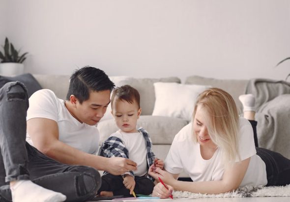 A joyful family drawing together indoors, fostering love and creativity.